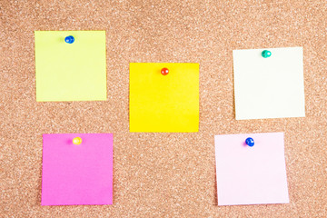 multicolor reminder sticky notes on cork board, empty space for text