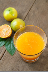 Fresh Orange juice with sliced fruit on the wood background
