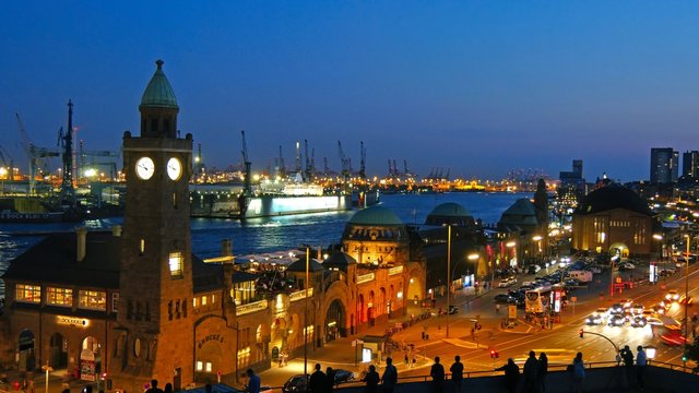 Landungsbruecken and the harbor at night in Hamburg, Germany. Time lapse