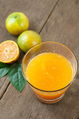 Fresh Orange juice with sliced fruit on the wood background