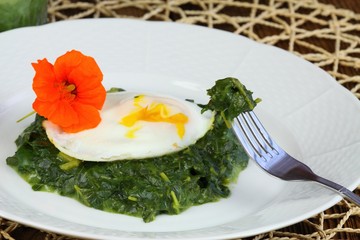 Spinach,  poached egg & edible flower  water cress