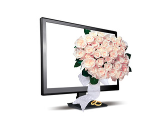 wedding rings and bouquet of flowers near the monitor
