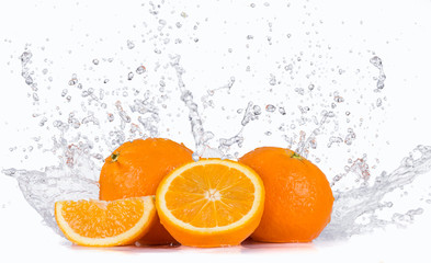 Fresh oranges with water splashes.
