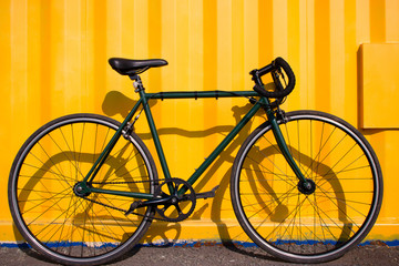 Fototapeta na wymiar city bike fixed gear on a yellow background
