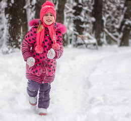 Happy 5 year old girl running on snow