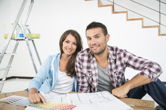 couple in new home choosing wall paint colors