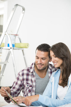couple in new home choosing wall paint colors