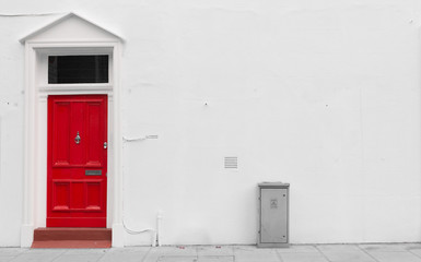 Red wooden door with silver mail door slot and door knocker