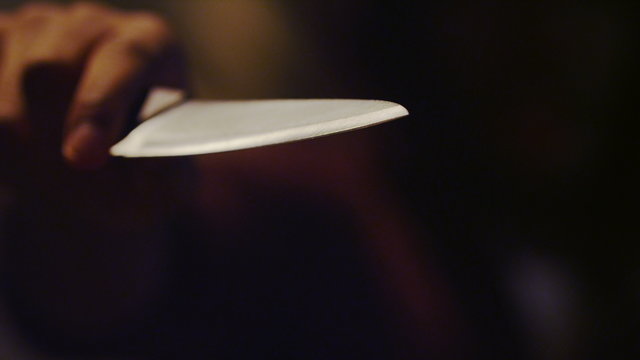 4K Hooded male threatening the viewer with a knife at night, shot on RED EPIC