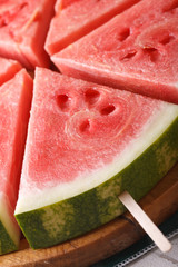 slices of watermelon on a stick macro. vertical
