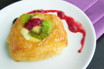 sweet breads and  strawberry jam on table