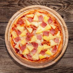 Hawaiian pizza on the old table