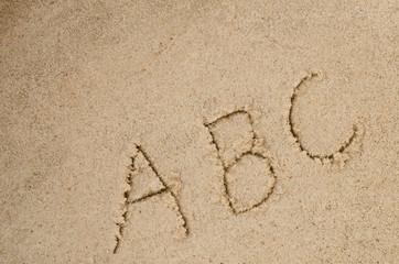 abc letters on sand