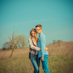 Young beautiful couple outdoor fashion portrait. Handsome man with pretty blond woman in love