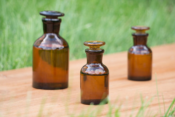 little brown bottles on booden board and grass