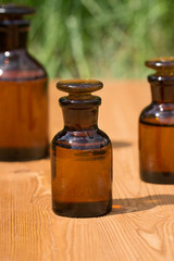 little brown bottles on booden board and grass