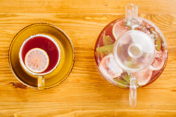 cup of tea and kettle  on wooden background