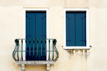 door with balcony and window on creme wall