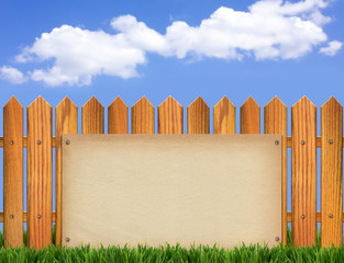 Wood fence and paper background on blue sky