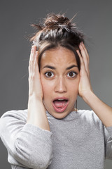 noise and fear concept - stunned 20s multiracial woman with brown hair protecting herself with both...