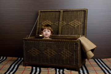 little girl sitting in suitcase 