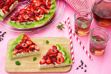 Sponge cake with strawberries and kiwi in shape of watermelon