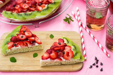 Sponge cake with strawberries and kiwi in shape of watermelon