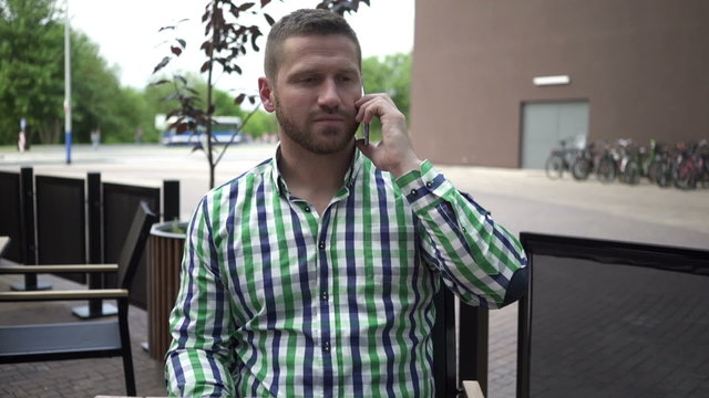 Man talking by the smartphone.
