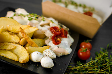 Delicious portion of rustic potatoes fillet with aromatic herbs
