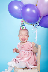 Fototapeta premium sad little girl with cap and balloons