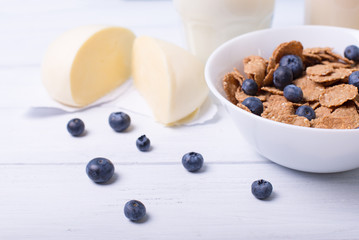Half view of a Close view of a cereals with blueberries with moazzarella and glass of milk on a background. with central focus and shallow depth of field