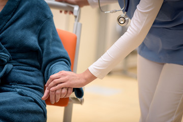 Doctor holding patient hand