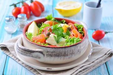 salad with salmon, lettuce, boiled eggs, cherry tomatoes, parmesan cheese and capers