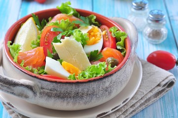 salad with salmon, lettuce, boiled eggs, cherry tomatoes, parmesan cheese and capers