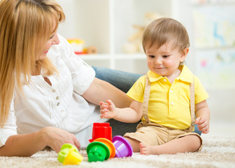 mother and kid playing block toys at home