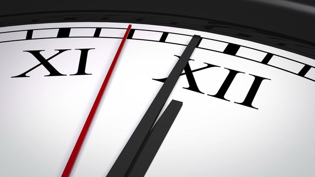 Close-up of a clock with Roman numerals striking twelve