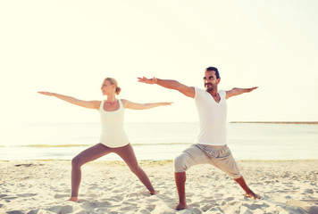 couple making yoga exercises outdoors