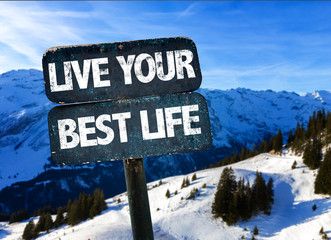 Live Your Best Life sign with winter landscape on background