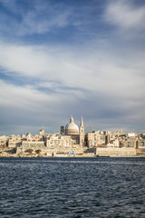 Obraz premium Valletta, Malta. A view over Marsamxett harbor of the skyline of the Maltese capital Valletta dominated by the dome of St. Paul's Anglican Cathedral.