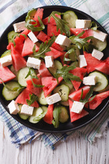salad with watermelon, cucumber and arugula closeup. vertical top view

