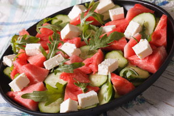Summer salad with feta, watermelon, cucumber and arugula 
