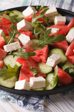 Fresh salad with feta, watermelon, cucumber and arugula close-up
