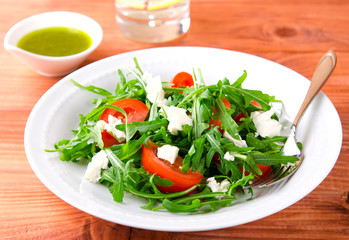 Green salad with arugula, tomatoes and feta cheese