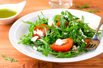 Green salad with arugula, tomatoes and feta cheese