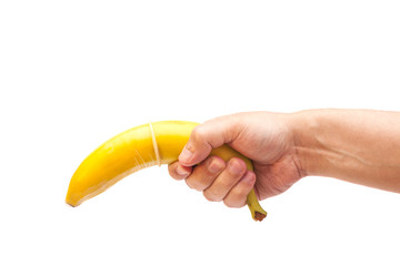 Condom on banana in hand isolated on white background - obrazy, fototapety, plakaty
