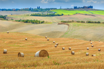 Obraz premium Old town and straw bales in Tuscany,Italy,Europe