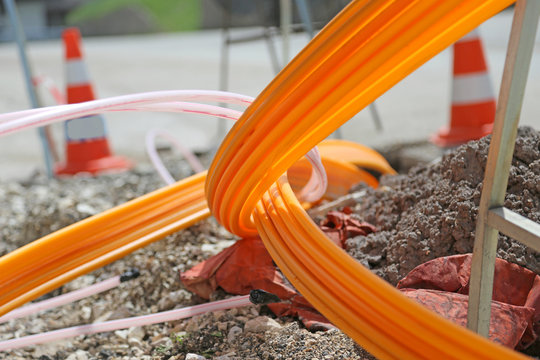 Orange pipes for fiber optics in a large city road construction