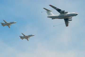 military aircraft with fuel and two fighters in the sky to refue