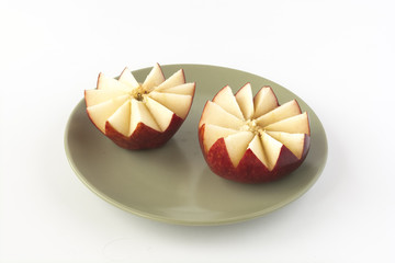 Fototapeta na wymiar Cut red apple on a ceramic plate