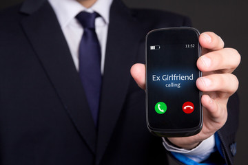male hand holding smart phone with incoming call from his ex gir - obrazy, fototapety, plakaty